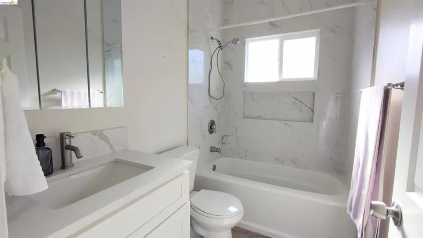 Bathroom with vanity and shower / washtub combination