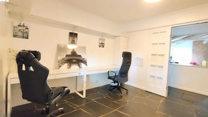 Home office with crown molding and baseboards