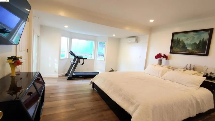 Bedroom featuring dark wood-style floors, recessed lighting, and ornamental molding