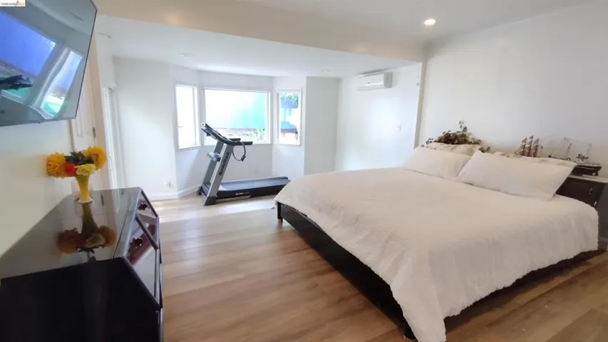 Bedroom with light wood-style flooring and recessed lighting