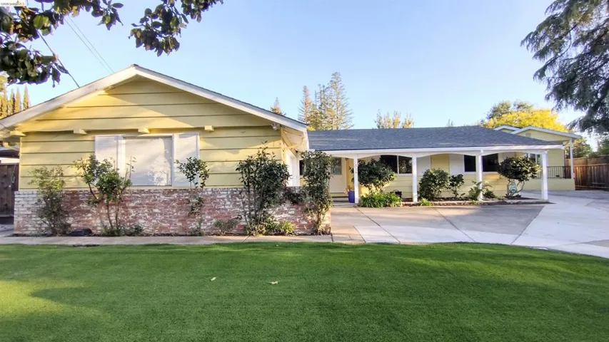 View of front of home with brick siding and a porch