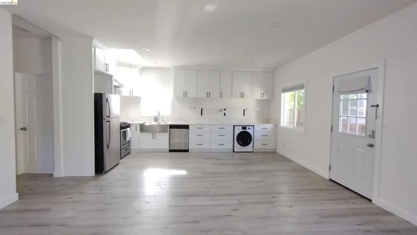 Laundry area featuring washer / dryer and light wood-style floors