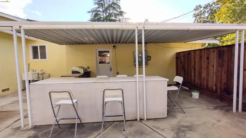 View of patio with a grill