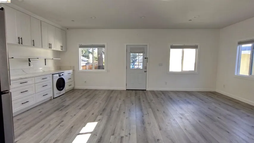 Laundry area featuring washer / clothes dryer and light wood-style floors