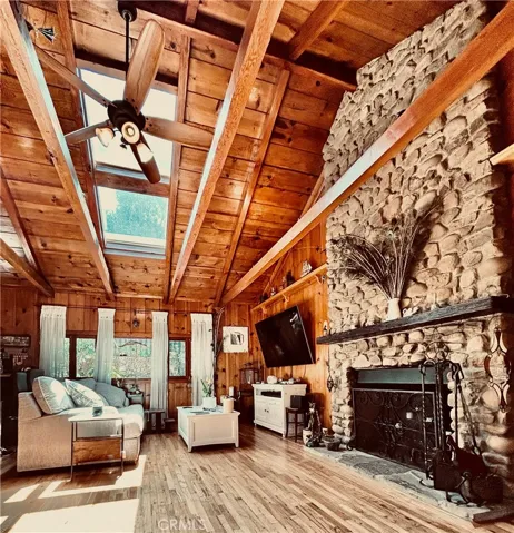 Living Room with cathedral ceilings and river rock fireplace