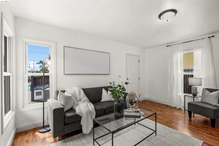 Living area with wood finished floors and healthy amount of natural light