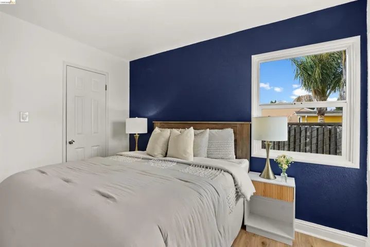 Bedroom with wood finished floors and baseboards