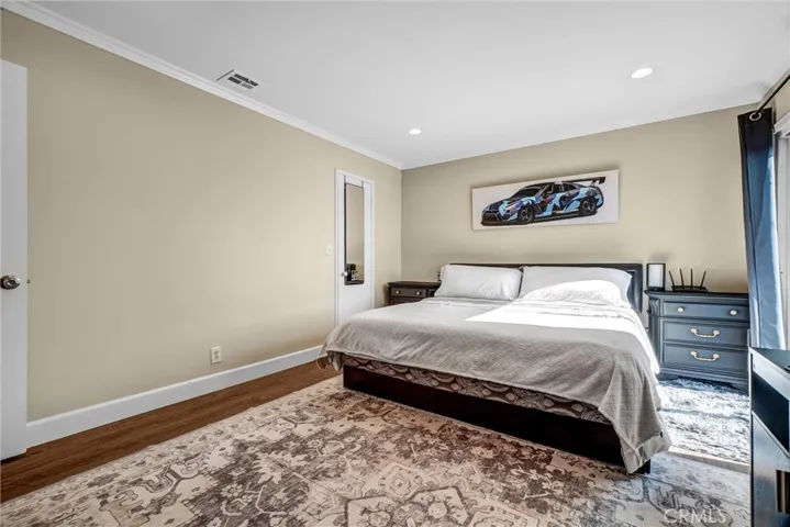Upstairs primary bedroom with ensuite bath and sun deck access