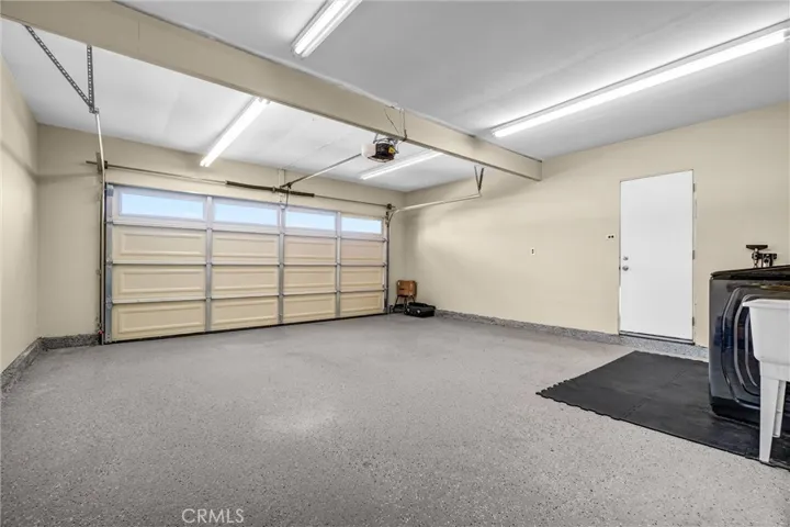 very clean attached 2-car garage with laundry, sink and epoxy floor. New garage & motor.