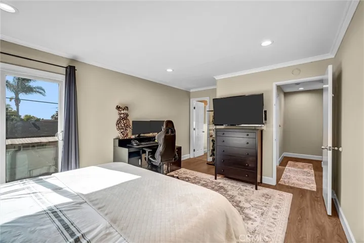 upstairs primary bedroom with sunset views from sliding door and access to sun deck