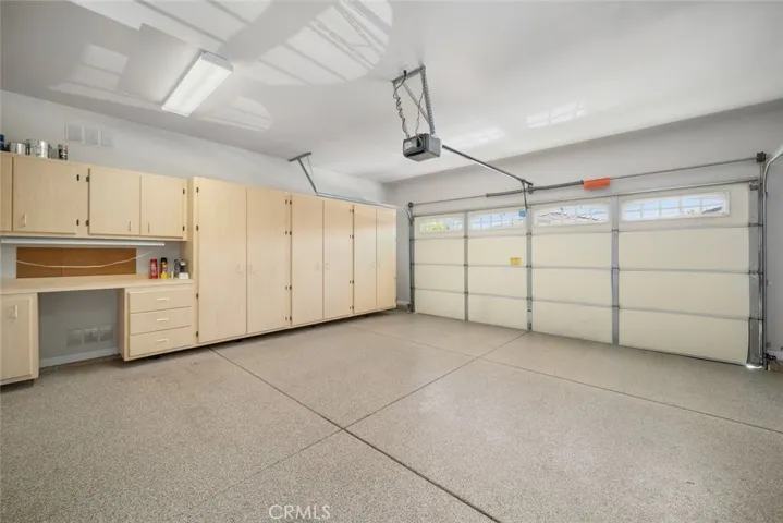 Garage with epoxy flooring, built in desk & storage & mini split AC