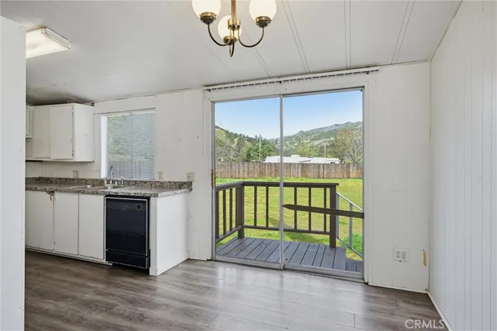 Dining area and kitchen open to large side yard

