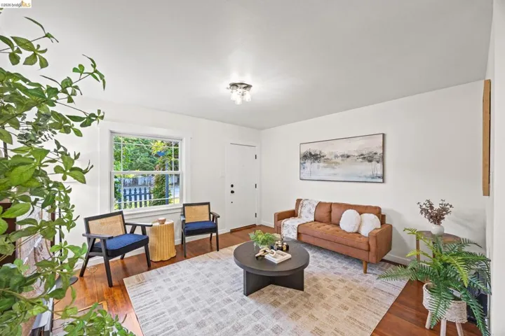 Living area with wood finished floors and baseboards