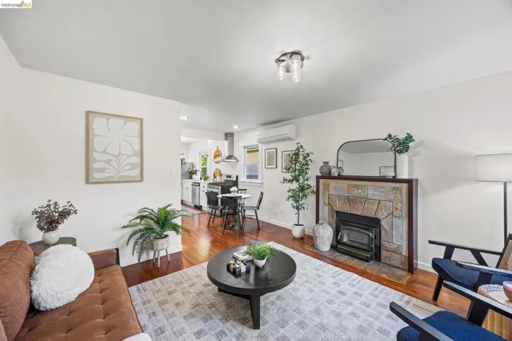 Living room featuring wood finished floors and a tiled fireplace