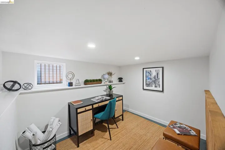 Office area with recessed lighting and light wood-style flooring