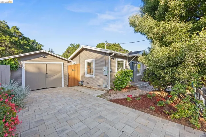 View of front of property with an outbuilding, driveway, crawl space, and a garage