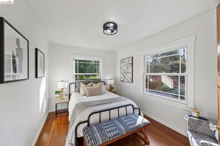 Bedroom with baseboards and dark wood-style flooring
