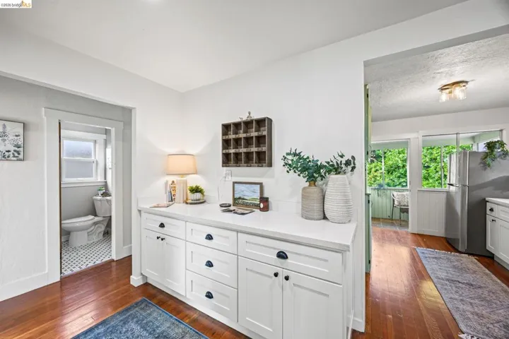 Hallway with dark wood-style flooring and baseboards