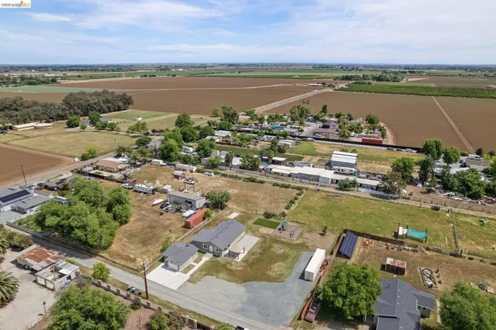 View of property location featuring rural landscape, abundant farmland, and nearby suburban area