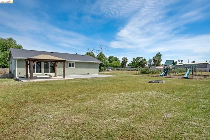 Rear view of property with a patio area and a gazebo