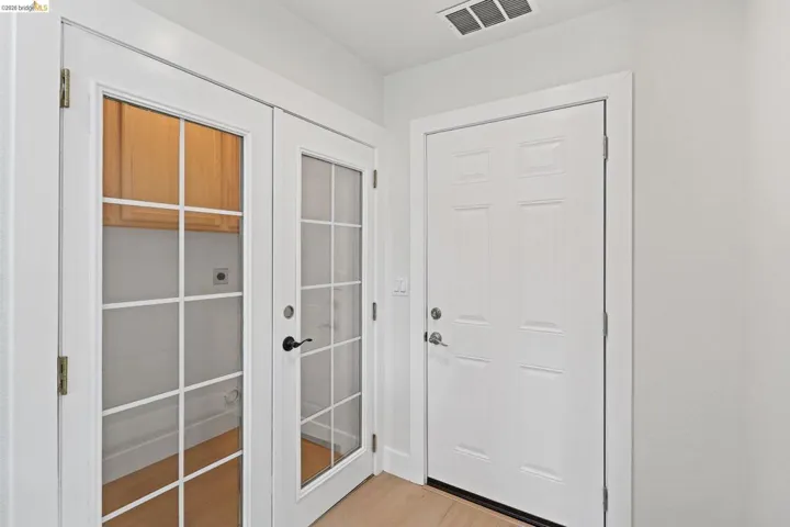Doorway with wood finished floors and french doors