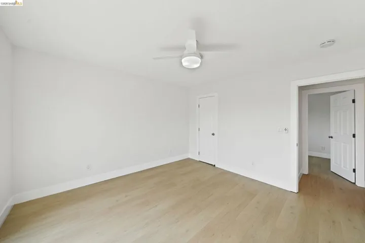 Unfurnished bedroom featuring light wood finished floors and a ceiling fan