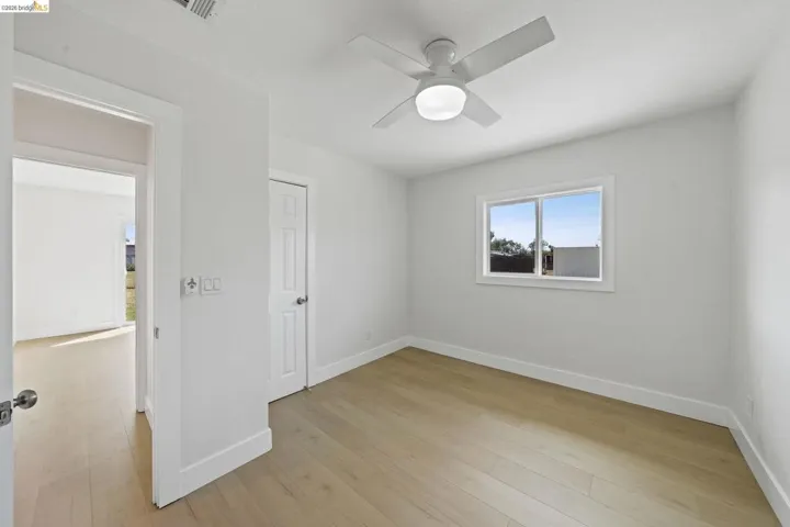 Spare room with a ceiling fan and light wood-style flooring