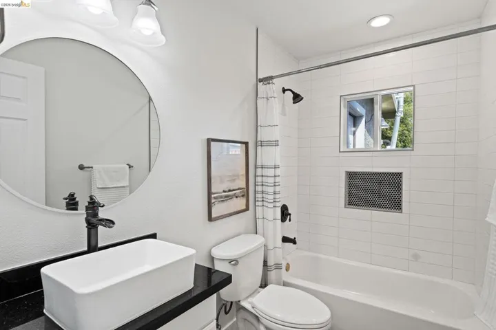 Bathroom with vanity and shower / tub combo