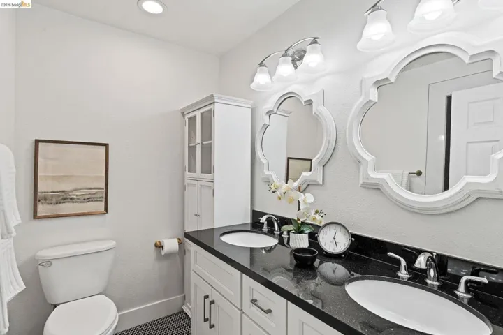 Bathroom featuring double vanity and toilet