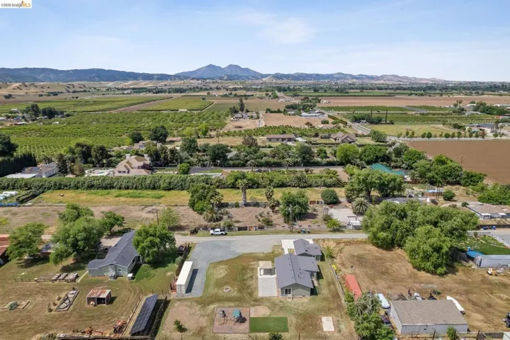 Overview of rural landscape featuring abundant farmland and a mountain backdrop