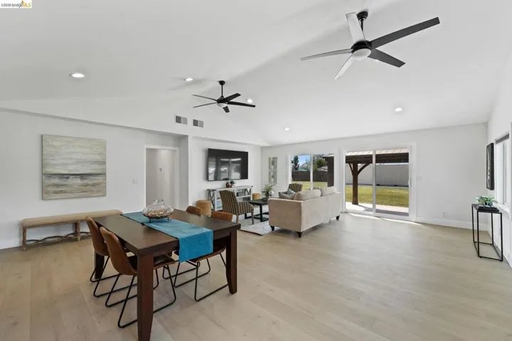 Dining room featuring a ceiling fan, recessed lighting, light wood-style flooring, and lofted ceiling