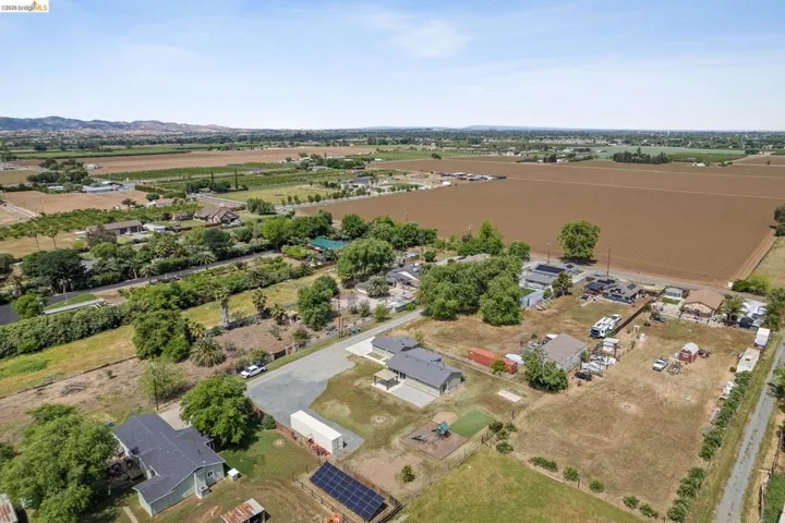 Aerial overview of property's location with rows of crops and rural landscape