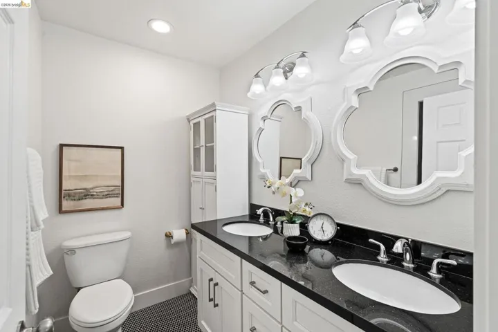 Bathroom featuring double vanity and toilet