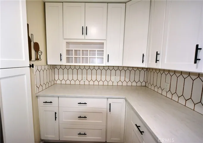 Large food prep area with extra cabinets.