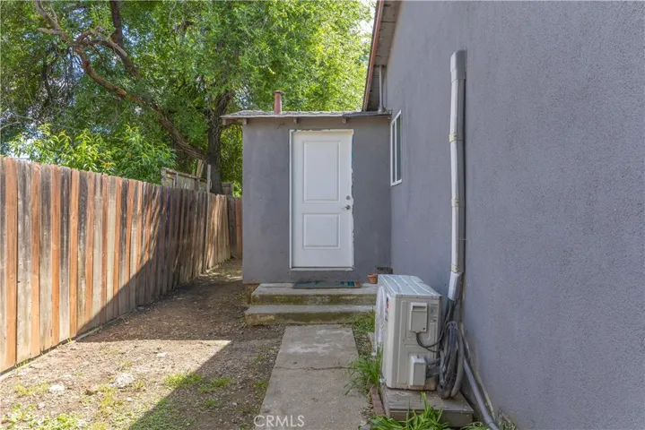 Side of house, door to laundry room, connected to kitchen.