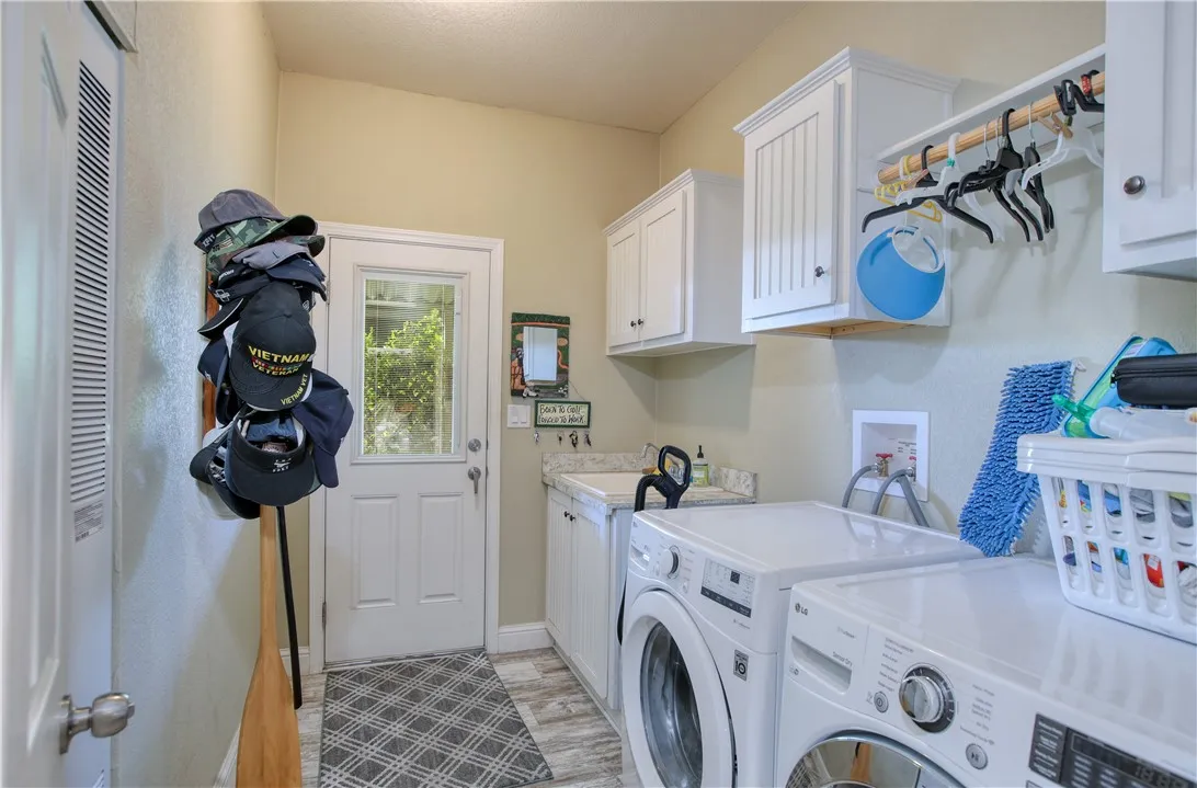Laundry room with utility sink and washer and dryer included.