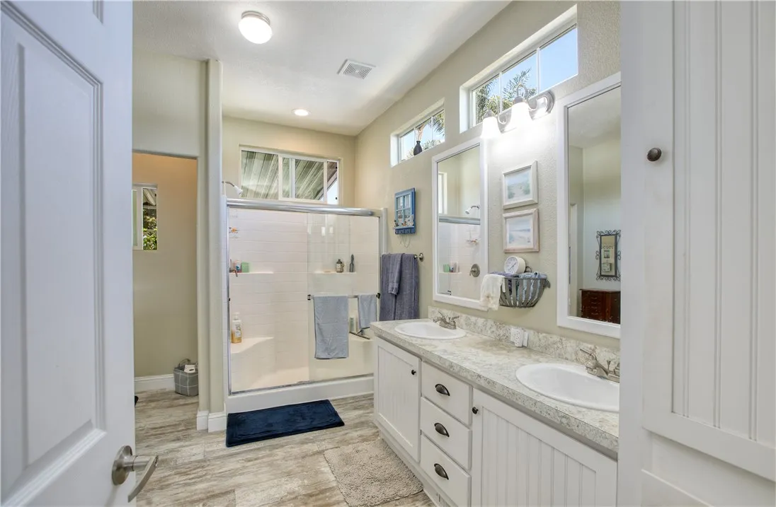 Primary bath with dual sinks, walk in shower and walk in closet.