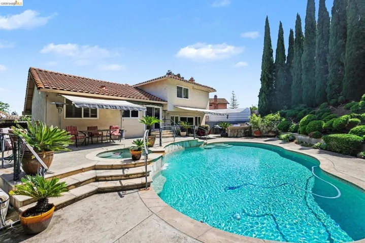 View of swimming pool with an in-ground hot tub, patio surround, and outdoor dining​​‌​​​​‌​​‌‌​​‌​​​‌‌​​​‌​​‌‌​​‌‌​​‌‌​​​​ space