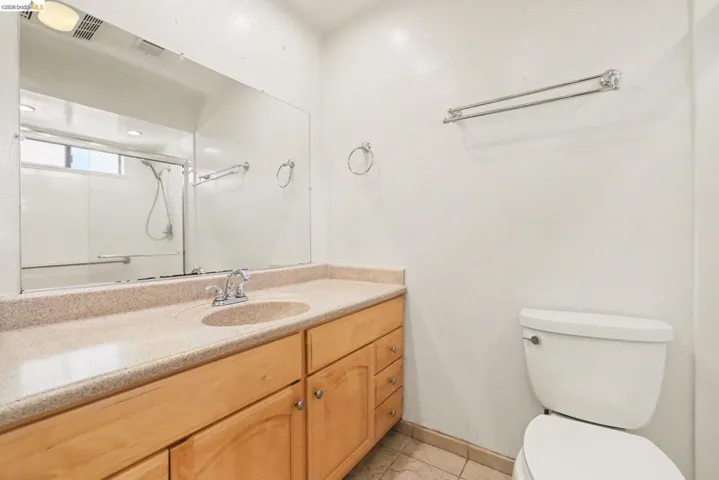 Master Bathroom with vanity, shower Stall with glass doors, tile floors