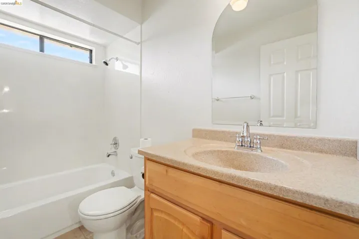 Bathroom featuring vanity and shower/tub combination