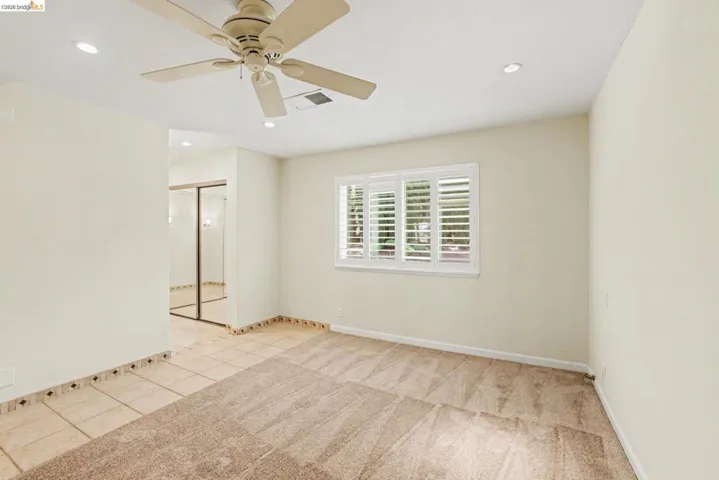Master Bedroom featuring ceiling fan, recessed lighting, tile floors and new carpet.