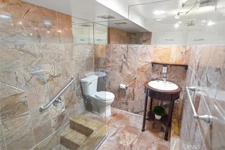 Beautiful tiled bath with roman style shower