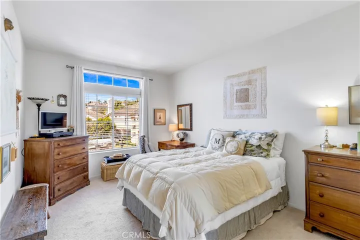 Large Primary bedroom with blinds to brighten your day and darken your sleeping.