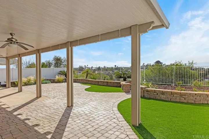 Pavers, newer vinyl fencing on both sides.