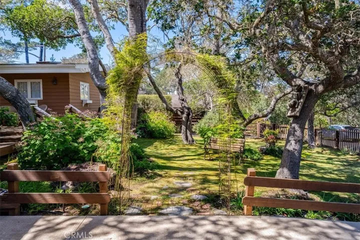 Beautifully landscaped front yard with archway entrance