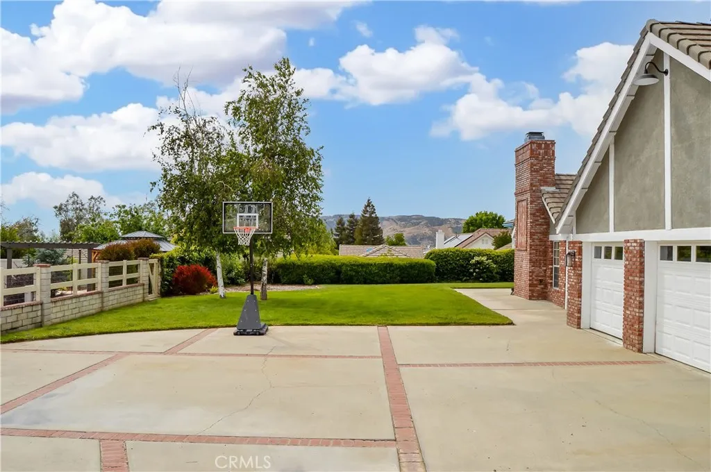 Generous driveway and lawn space with mountain views in the distance