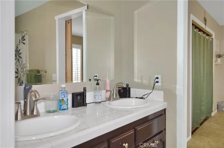 "Jack and Jill" bath with dual sinks and shower in tub with barn doors on both sides