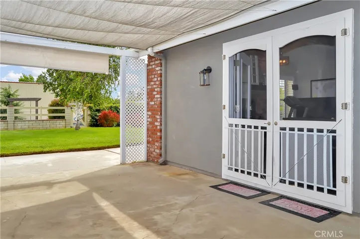 This spacious patio outside the family room offers a shade cover, dual ceiling fans, and a fun fountain to enjoy while barbecuing or just relaxing in the shade.