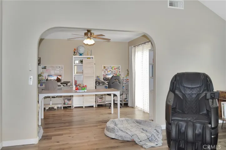 The living room is open to the dining room which is used as a study and hobby space. (Screen images added virtually)