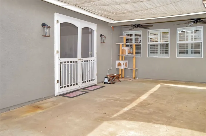 This spacious patio outside the family room offers a shade cover, dual ceiling fans, and a fun fountain to enjoy while barbecuing or just relaxing in the shade.